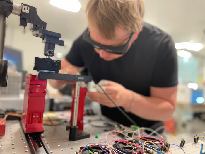Elias Holmqvist prepares fiber optics for the microphone